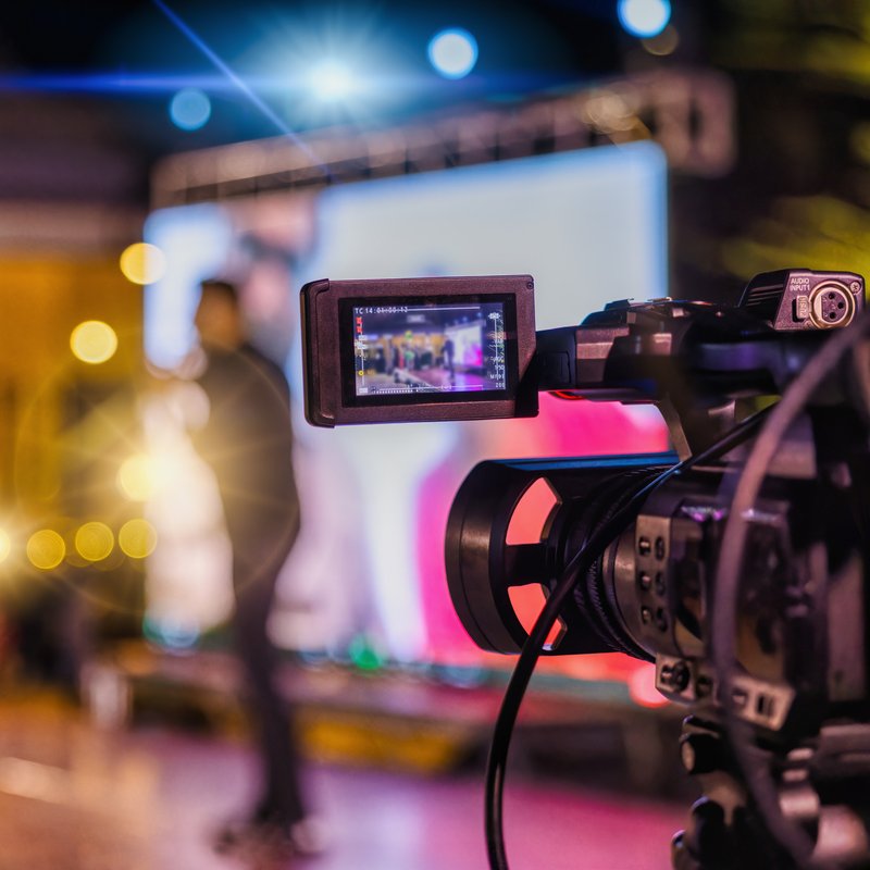 A video camera capturing a live event on stage